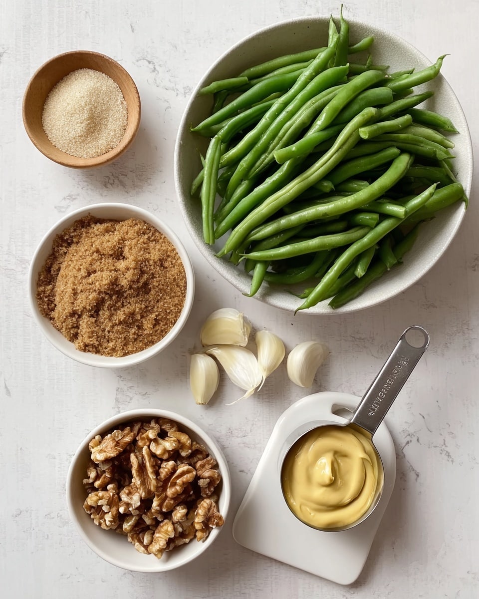 A top-down view shows six items arranged on a white marbled surface. On the left is a large white bowl full of fresh green beans, bright and smooth. Nearby is a smaller white bowl filled with brown sugar, coarse and crumbly. Three whole garlic cloves sit beside it, creamy beige in color. Next, a tiny light wood bowl holds salt and pepper. Below is another small white bowl with a creamy pale yellow spread. At the bottom left, a medium white bowl is filled with toasted walnuts, rich brown and textured. To the right, a metal measuring cup filled with smooth yellow mustard rests on a small white square dish with a handle extending to the right. Photo taken with an iphone --ar 4:5 --v 7
