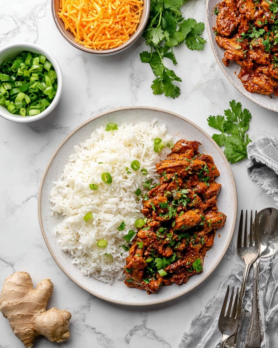 On a white plate, there are two main layers: cooked white rice fills the left half with a fluffy texture and a few green onion pieces sprinkled on top, while the right half has a reddish-brown saucy mixture with chunks of cooked protein that looks soft and moist, garnished with fresh green cilantro leaves and chopped green onions. Around the plate on a white marbled surface, there are bowls of shredded orange cheese and chopped green onions, a fresh cilantro bunch, a silver fork and spoon crossed beside the plate, and a piece of fresh ginger root. The scene is bright and clean with a casual dining feel photo taken with an iphone --ar 4:5 --v 7