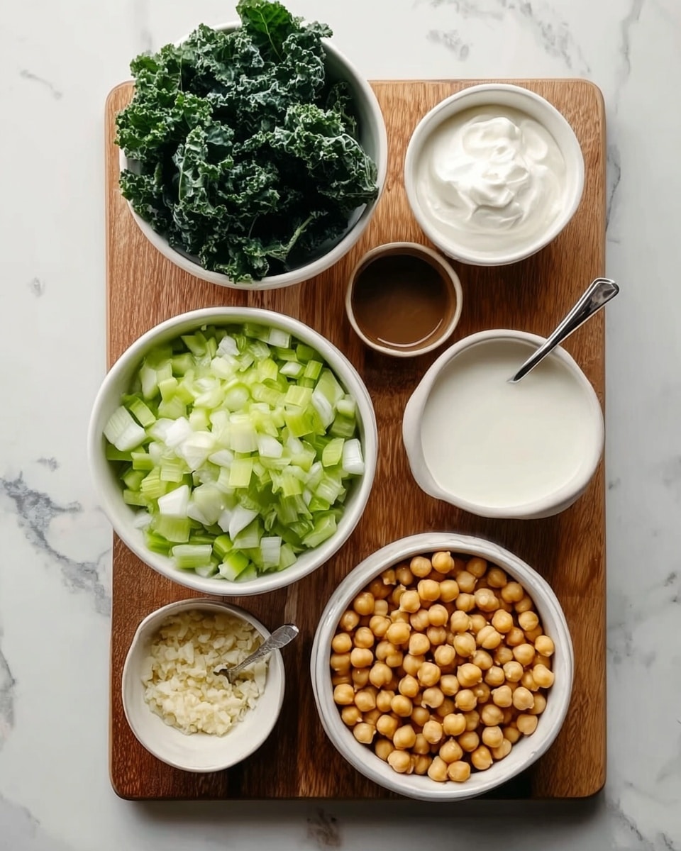The image displays a wooden board on a white marbled surface with six white bowls of different sizes, each containing separate ingredients for a dish. In the center, there is a large bowl filled with chopped light green celery and onion pieces. To the lower right is another large bowl filled with round, beige chickpeas. To the upper left, a smaller bowl holds dark green leafy kale. A small bowl at the top right contains thick white cream or sour cream. Below the kale, a medium bowl contains a dark brown liquid, possibly broth or sauce. To the lower left, a medium bowl is filled with a white creamy ingredient, possibly yogurt or mayonnaise. Lastly, a very small white bowl at the bottom left contains finely chopped light beige ingredients, likely minced garlic. The arrangement is neat and all bowls are clean and white. Photo taken with an iphone --ar 4:5 --v 7