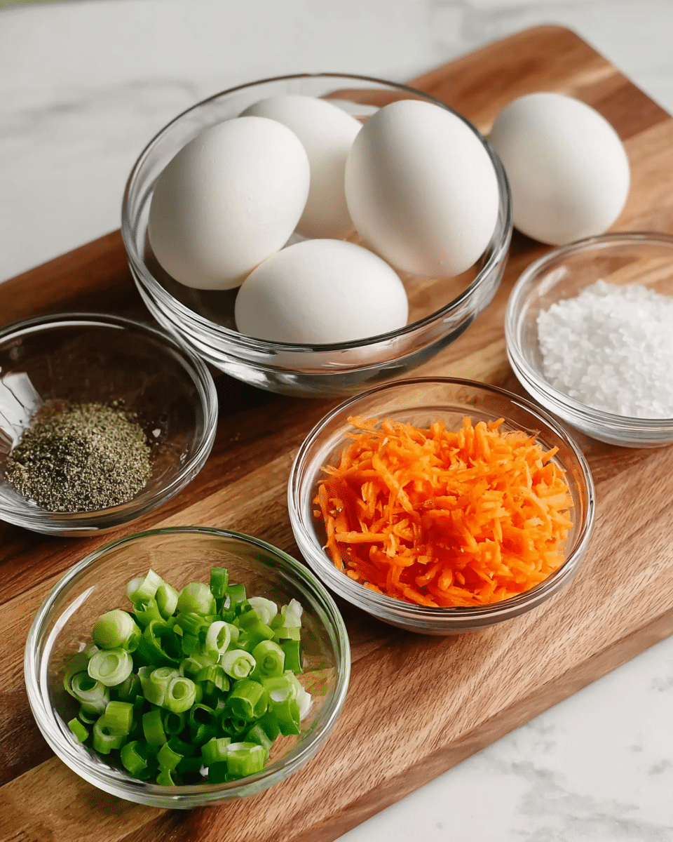 A wooden board holds five clear glass bowls arranged in a loose cluster. The largest bowl, centered at the back, contains five plain white eggs with smooth shells. In front to the right is a small bowl filled with shredded bright orange carrots, and to the left of it, another small bowl holds chopped green onions with vivid green and white rings visible. To the left near the front is a small bowl with ground black pepper in a grayish-brown color. Behind it, another small bowl contains coarse white salt crystals. The setting is on a white marbled surface, adding a clean, light background. Photo taken with an iphone --ar 4:5 --v 7