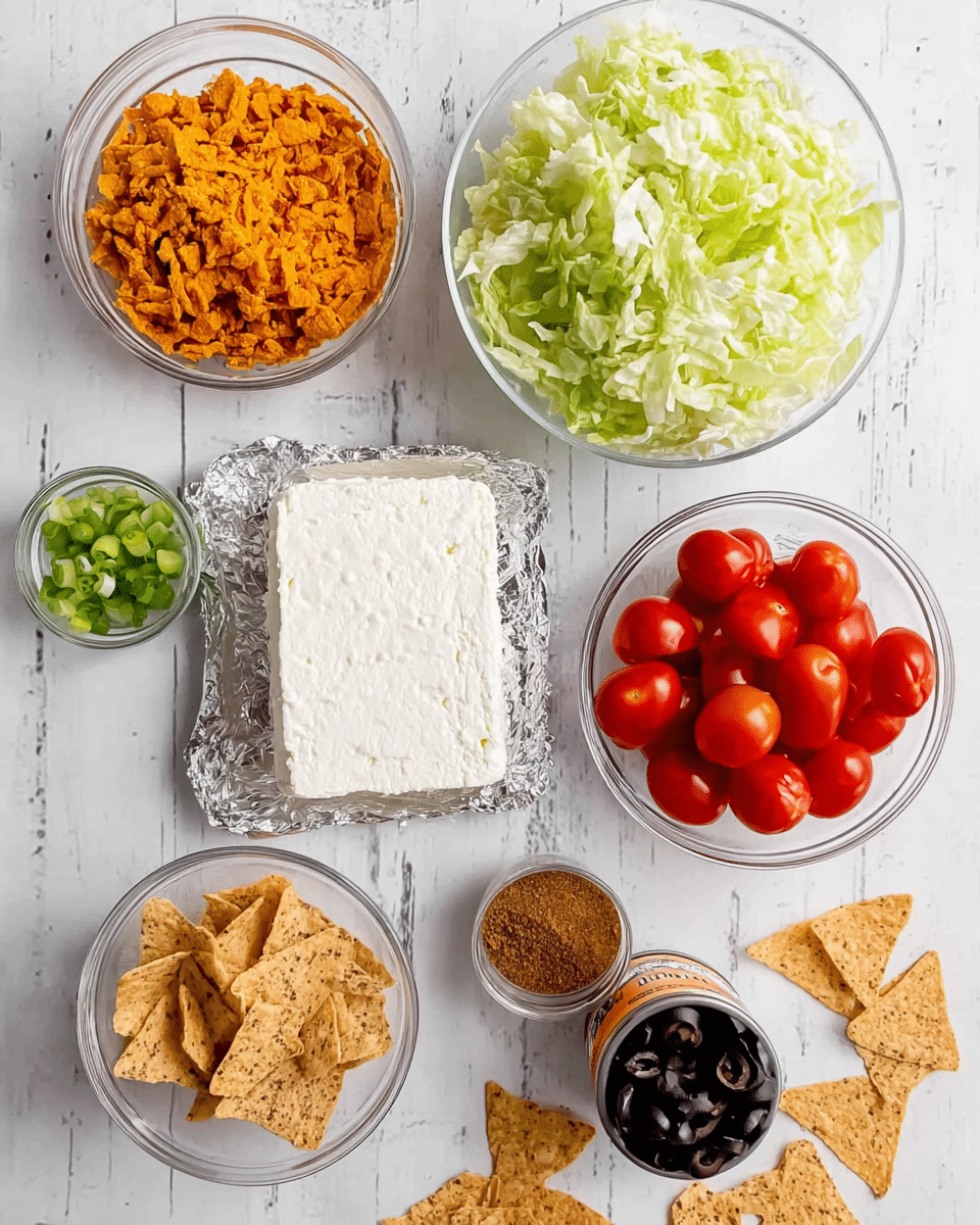 The image shows eight bowls arranged on a white marbled surface. In the center, there is a block of white cheese resting on silver foil. Above the cheese is a clear glass bowl filled with light green shredded lettuce. To the right of the lettuce is another clear bowl with bright red halved cherry tomatoes. Below the tomatoes is a small clear bowl with chopped green onions. Below the cheese and to the left, there is a clear bowl filled with crushed orange chips. To the right of the crushed chips is a bowl containing a light brown powder-like substance. Above the brown powder and to the left is a small black bowl filled with sliced black olives. There are also some whole light brown triangular chips scattered around the bowls. Photo taken with an iphone --ar 4:5 --v 7