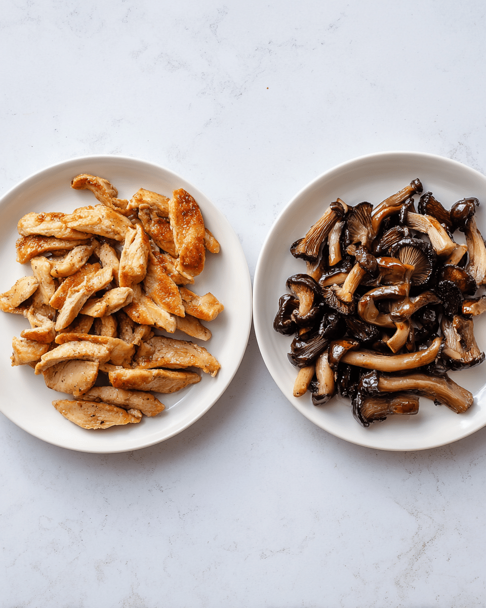Two white plates sit side by side on a white marbled surface. The left plate holds light golden-brown cooked chicken strips with a slightly crispy texture. The chicken slices are uneven in shape and layered loosely. On the right plate, there is a pile of cooked sliced mushrooms, dark brown and glossy, showing a tender and slightly moist texture. The mushrooms are piled up, showing different sizes and curved shapes. photo taken with an iphone --ar 4:5 --v 7