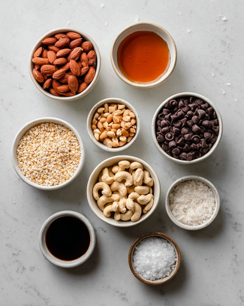 The image shows eight white bowls arranged on a white marbled surface. From the top left, the first bowl is filled with whole almonds that are reddish-brown and smooth. To its right, there is a bowl with thick amber honey that has a shiny texture. Below the almonds, a bowl contains small, light brown peanuts, and next to it, on the right, a bowl holds light beige cashew nuts with a slight curve. Below the peanuts, there is a bowl filled with puffed rice that is pale and textured. To the right of this, the largest bowl is filled with glossy dark brown chocolate chips. At the bottom right, the smallest bowl contains flaky white salt, and next to it, on the left, there is a small bowl with a dark brown liquid, likely vanilla extract. photo taken with an iphone --ar 4:5 --v 7