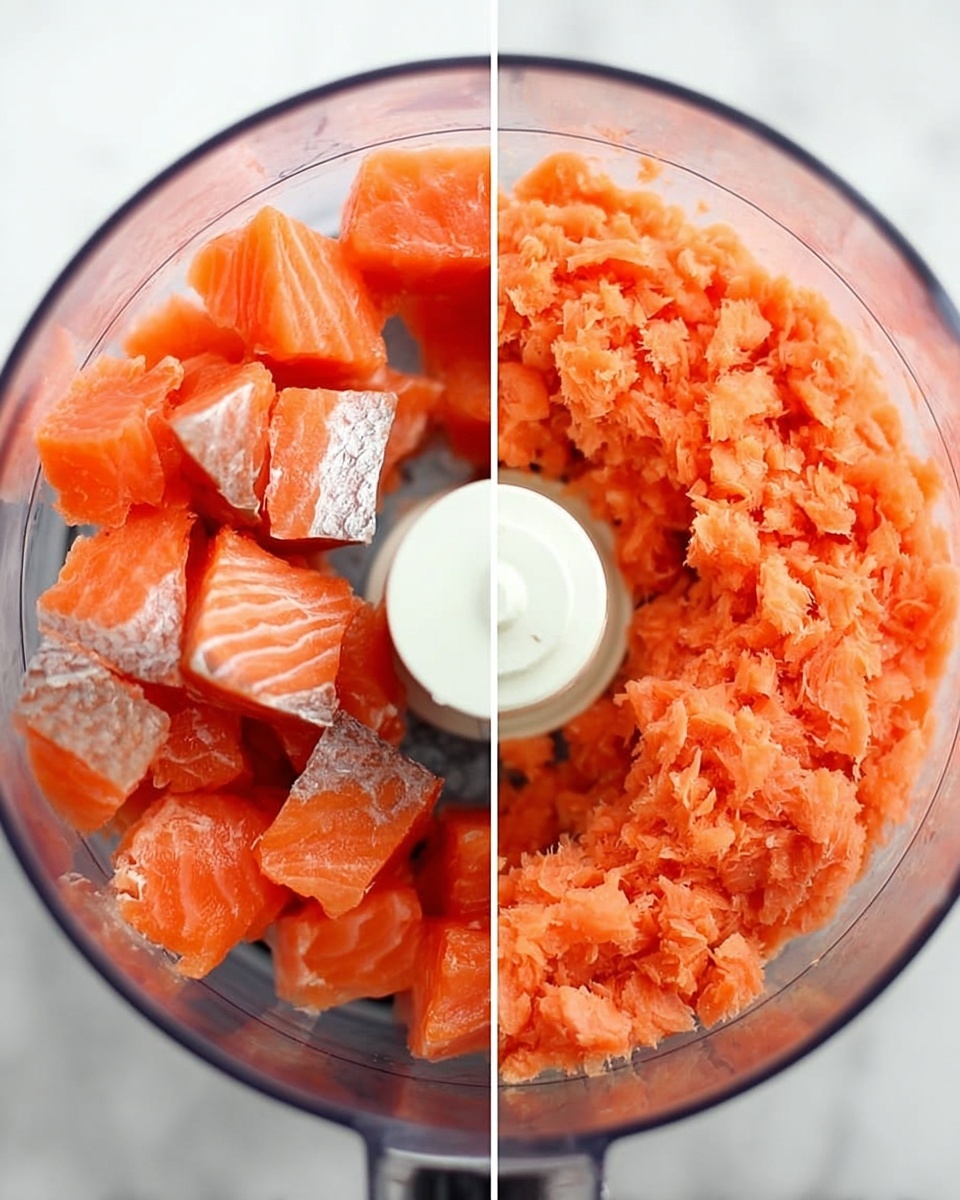 The image shows two side-by-side close-up views inside a clear food processor bowl on a white marbled surface. On the left side, the food processor bowl is filled with fresh, bright orange salmon chunks with visible white stripes and some darker skin patches around the edges. On the right side, the food processor bowl now contains finely chopped salmon with a soft, slightly moist texture and a uniform orange color that fills the bowl more evenly. The white central blade of the food processor is visible in both bowls. photo taken with an iphone --ar 4:5 --v 7