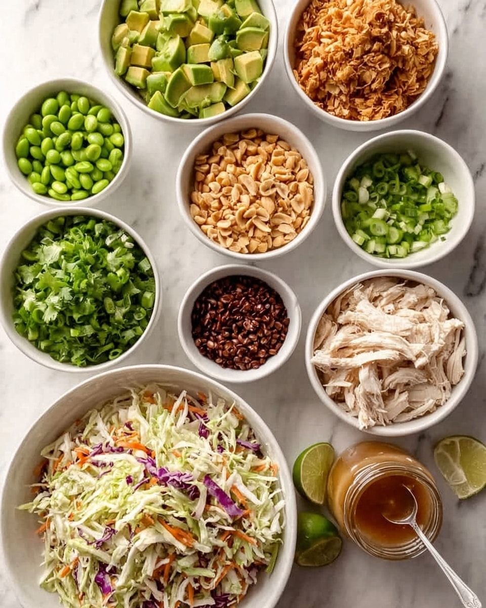 The image shows eight white bowls arranged on a white marbled surface. Starting from the top left, a bowl filled with bright green avocado chunks is next to a bowl of vibrant green edamame beans. Below these, small bowls contain thinly sliced green onions, light brown chopped peanuts, and dark brown toasted shredded coconut. The center bowls include light beige shredded chicken beside a pile of fresh green chopped cilantro. At the bottom, a large bowl holds a colorful coleslaw mix with white, purple cabbage, and orange carrot shreds. A glass jar of light brown sauce with a spoon and a cut lime sit near the bowls. Photo taken with an iphone --ar 4:5 --v 7