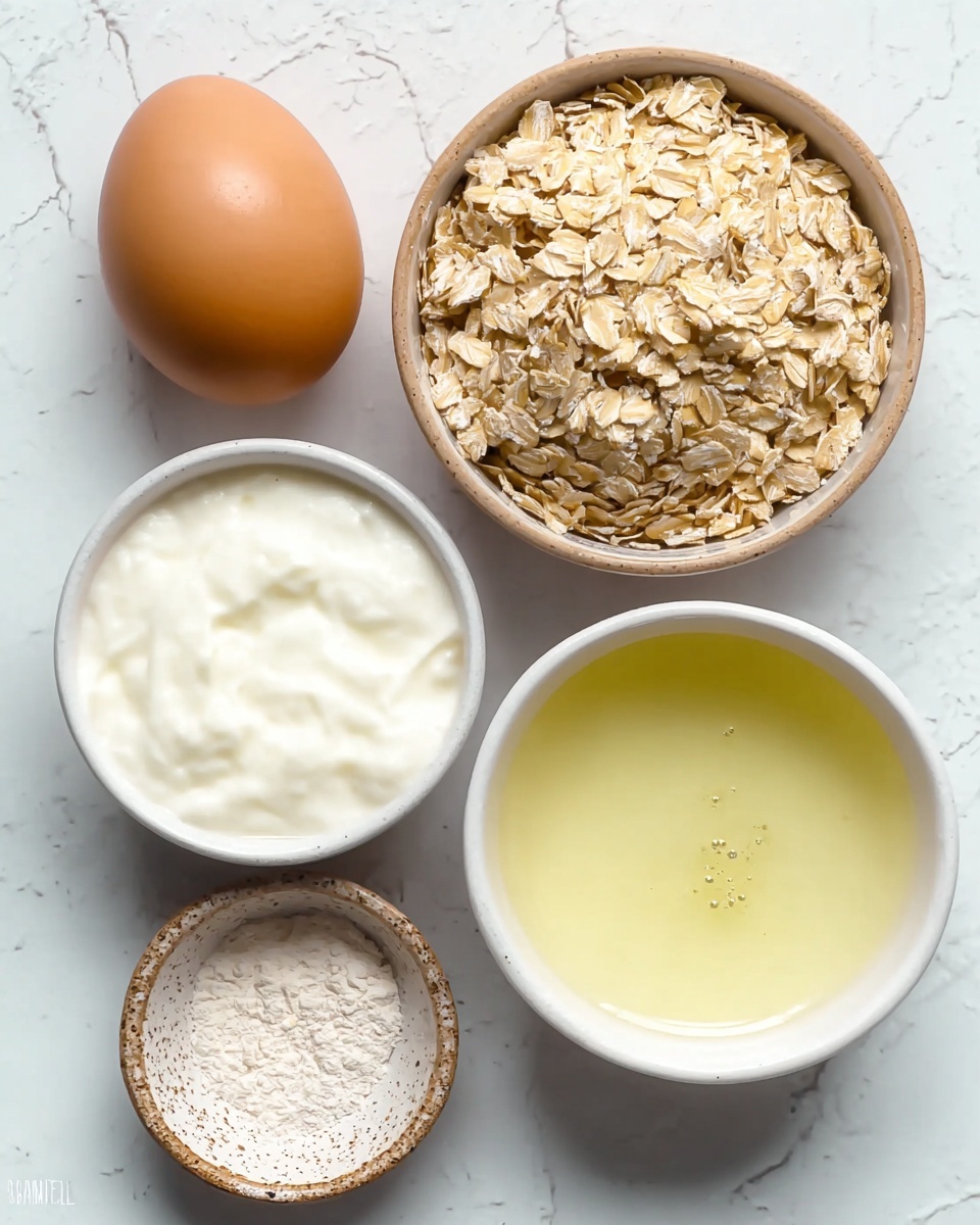 The image shows five cooking ingredients neatly arranged on a white marbled surface. At the top right, there is a small light brown bowl filled with light tan rolled oats, showing rough texture and many flakes. To its left, there is a whole brown egg with smooth, shiny shell. Below the egg, there is a small white container filled with thick, white yogurt that has a creamy texture. To the right of the yogurt, there is another white container holding a light yellow liquid with some small bubbles on the surface, likely oil or melted butter. At the bottom left, a small speckled brown bowl holds a small amount of fine white powder, possibly baking powder or flour. The composition is clean and simple, clearly showing each ingredient’s color and texture photo taken with an iphone --ar 4:5 --v 7