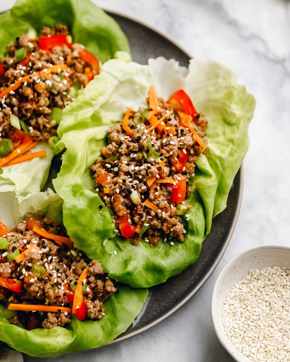 The image shows three lettuce wraps on a white plate with a dark inner surface, placed on a white marbled background. Each wrap has three main layers: the bottom layer is large crisp pale green lettuce leaves that fold inward to form a cup shape; the middle layer is a mix of cooked minced meat and small pieces of orange and red bell peppers, with thin orange carrot strips adding texture; the top layer is sprinkled with white and black sesame seeds. On the right side of the image, a small white bowl filled with white sesame seeds over black sesame seeds is visible. photo taken with an iphone --ar 4:5 --v 7