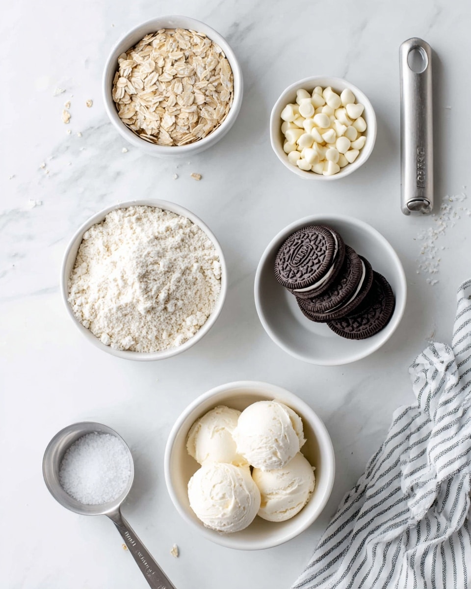 The image shows five small white bowls on a white marbled surface. The center bowl holds white flour with a crumbly texture. To the top right, a bowl contains small, smooth white chocolate chips. Below this, another bowl has four dark chocolate sandwich cookies stacked together, showing their detailed patterns. At the bottom center, a bowl holds several large scoops of white cream with a soft and smooth texture. On the left side, a bowl is filled with light beige rolled oats with a slightly rough texture. Above the flour bowl, a metal measuring spoon filled with salt lies flat. A striped cloth and a silver ice cream scoop with a white handle rest on the right edge. Photo taken with an iphone --ar 4:5 --v 7