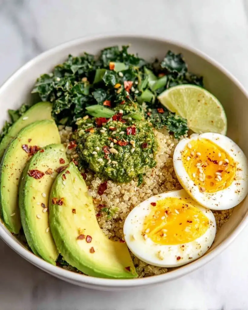 Savory Quinoa Breakfast Bowl with Soft-Boiled Eggs, Kale, Avocado, and Pesto Recipe