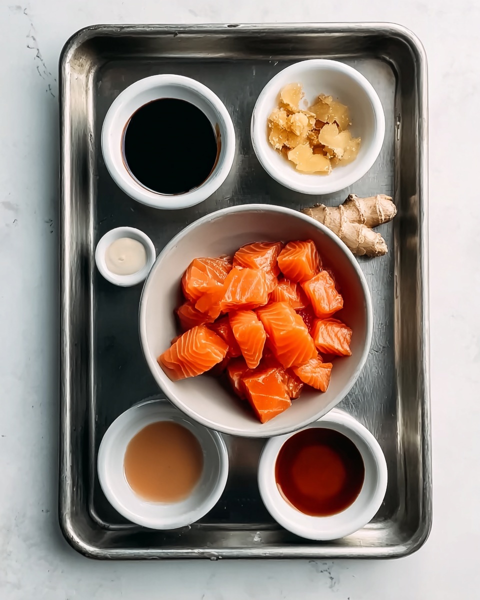 The image shows a metallic baking tray with six small white bowls placed on it, all arranged neatly on a white marbled surface. The central bowl is filled with bright orange cubes of fresh salmon with smooth, slightly shiny texture. Surrounding it are five smaller bowls containing different ingredients: a dark black sauce with a glossy surface at the top left, small pieces of light golden ginger at the top right, a light brown liquid at the middle left, a creamy white sauce at the bottom left, and a reddish-brown sauce with a smooth finish at the bottom right. The overall look is clean and organized with each element clearly visible. photo taken with an iphone --ar 4:5 --v 7