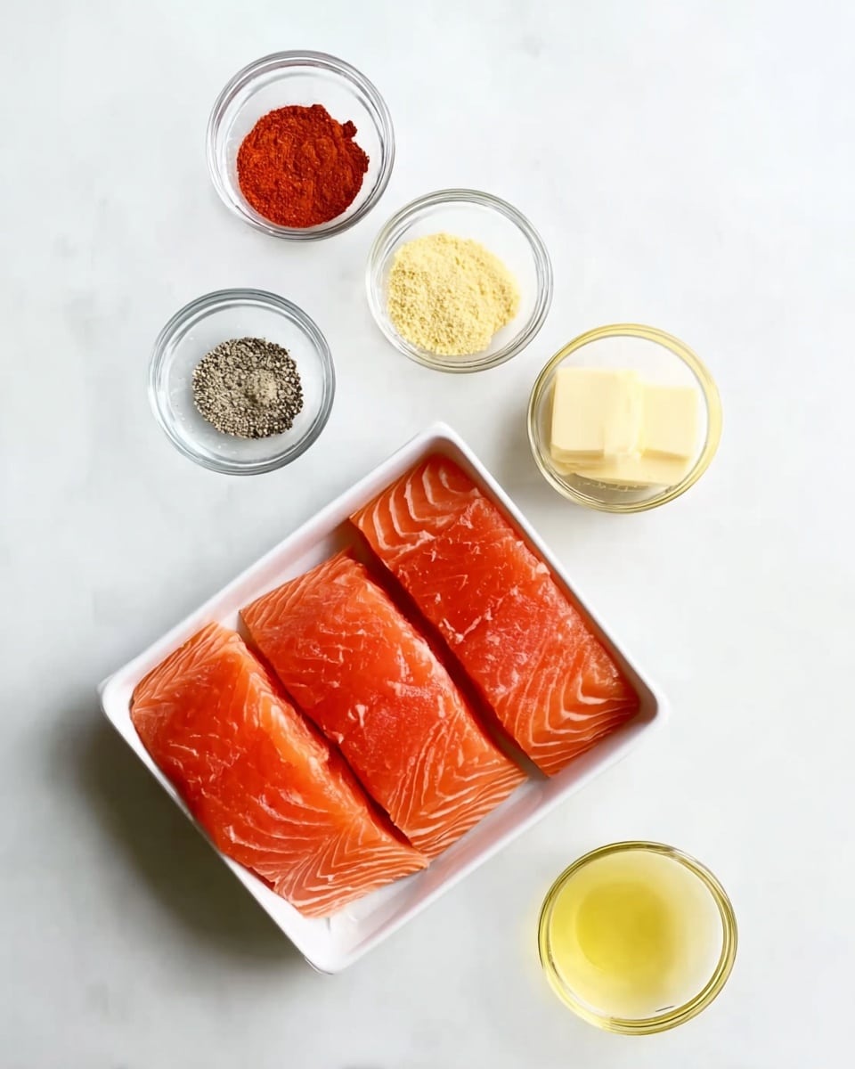 The image shows four raw salmon fillets placed neatly inside a white rectangular tray positioned on the right side of the frame. Surrounding the tray are five small clear glass bowls arranged in a loose circle against a white marbled background. Each bowl contains a different ingredient: bright red paprika powder at the top left, pale yellow garlic powder at the top center, coarse black pepper at the bottom left, a pale yellow block of butter at the bottom center, and a light yellow liquid of oil at the bottom right. The clean, simple arrangement highlights the colors and textures of the ingredients and salmon. Photo taken with an iphone --ar 4:5 --v 7