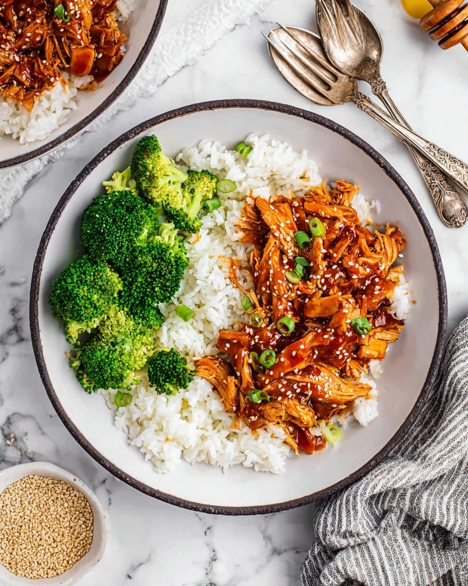 The dish is served on a white plate with a thin dark edge. The bottom layer consists of fluffy white rice, spread evenly across the plate. On one side of the rice, bright green steamed broccoli florets are placed in a small cluster, showing their textured surface and stems. On the other side, shredded chicken covered in a glossy reddish-brown sauce is layered generously, with sesame seeds sprinkled on top and small pieces of green onion as garnish. The background is a white marbled surface, with two ornate silver forks resting near the plate and a striped cloth napkin partially visible. A small bowl of sesame seeds and a honey dipper on a small dish complete the setting. photo taken with an iphone --ar 4:5 --v 7